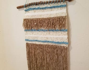 Hand woven wall hanging in brown, cream and turqoise