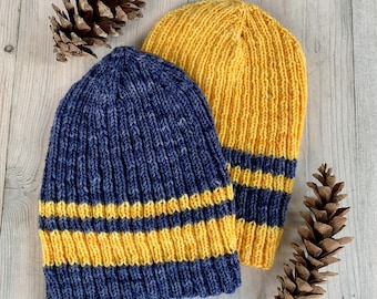 May include: Two knitted hats with yellow and blue stripes. The hat on the left is blue with yellow stripes, and the hat on the right is yellow with blue stripes.