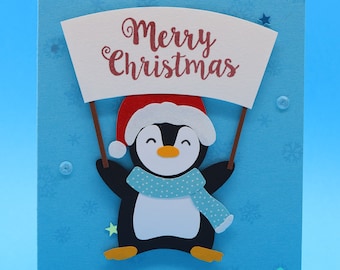 Tarjeta navideña "Pingüino con cartel de Feliz Navidad"
