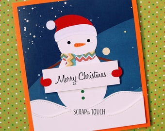 Tarjeta de feliz Navidad "Muñeco de nieve con cartel de Feliz Navidad"