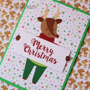 Merry Christmas card "Reindeer with Merry Christmas sign"
