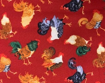May include: A red fabric with a repeating pattern of colorful roosters. The roosters are in various poses and have different colored feathers.