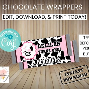 May include: Printable chocolate bar wrappers with a cow print design. The wrapper says "Delilah Turns One!" and features a pink and black cow illustration. The text "Hershey's" is also included on the wrapper.