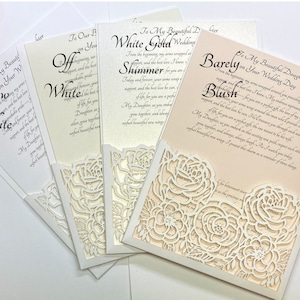 May include: Four white wedding cards with a lace overlay. The cards have different text on them, including "Snow White", "Off White", "Shimmer", and "Barely Blush".
