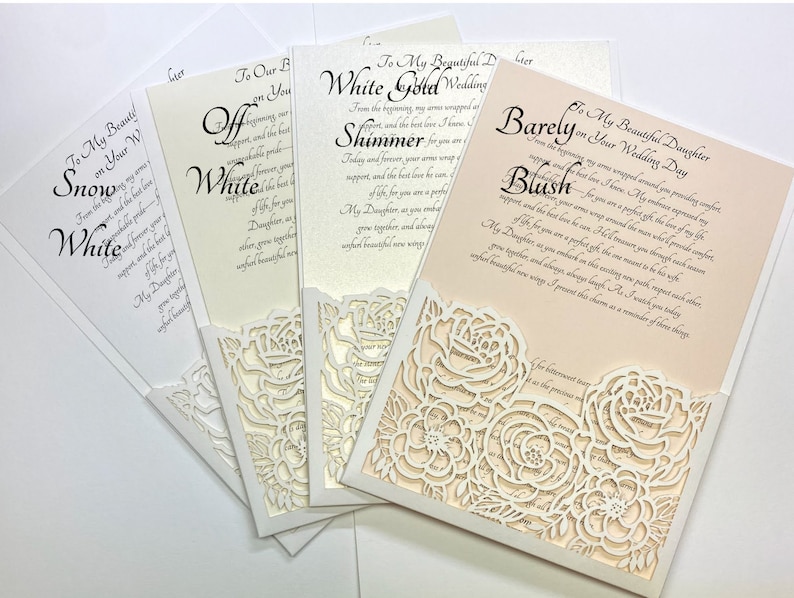 May include: Four white wedding cards with a lace overlay. The cards have different text on them, including "Snow White", "Off White", "Shimmer", and "Barely Blush".