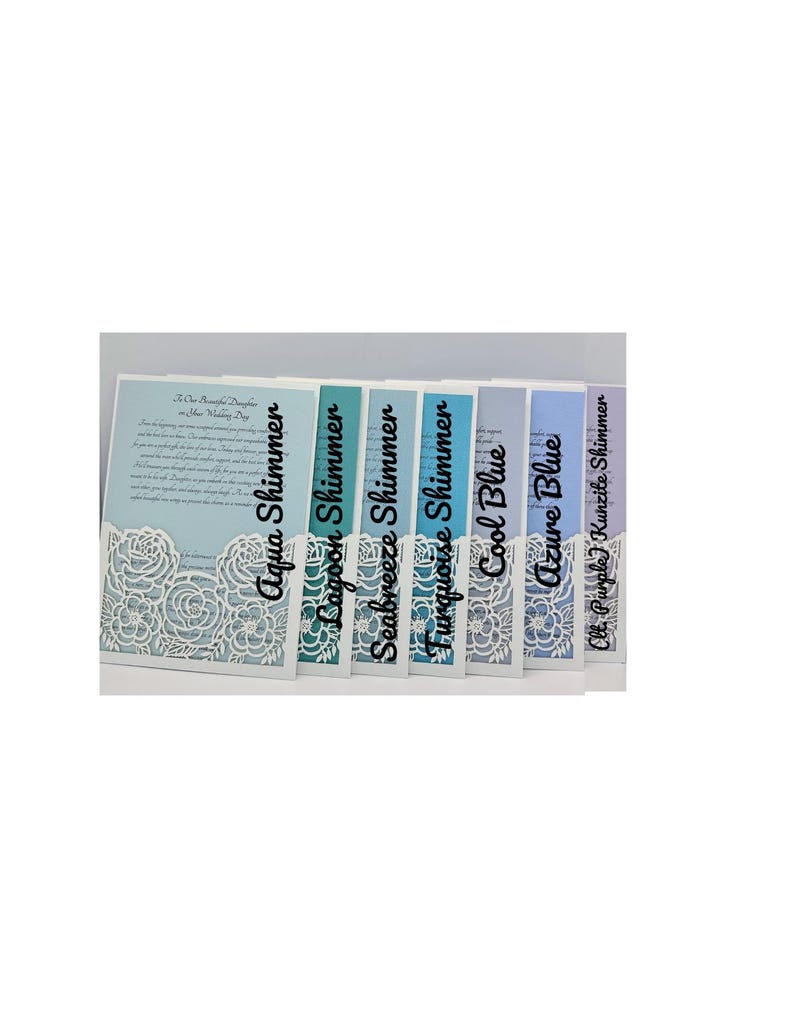 May include: Seven different color swatches of cardstock paper with a white lace overlay. The colors are aqua shimmer, lagoon shimmer, seabreeze shimmer, turquoise shimmer, cool blue, azure blue, and light purple kunzite shimmer.