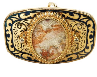 May include: Gold-toned belt buckle with a central oval stone featuring a mix of brown, white, and orange patterns. The buckle has a blue enamel border with ornate gold filigree and decorative accents.