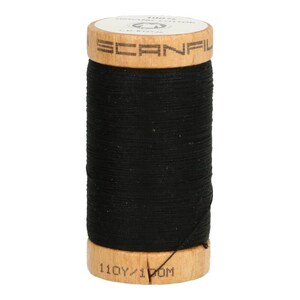 Könnte beinhalten: Eine Spule mit schwarzem 100% Bio-Baumwollgarn mit einer Holzspule. Die Spule ist mit "Scanfil 110Y/1.00M" beschriftet.