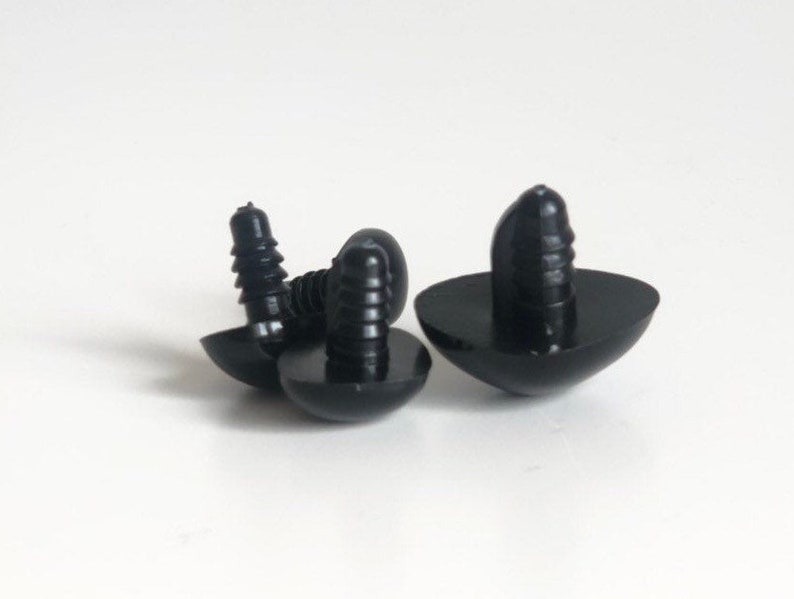May include: Three black plastic safety eyes with a screw-on back. The eyes are designed for use in stuffed animals or other crafts.