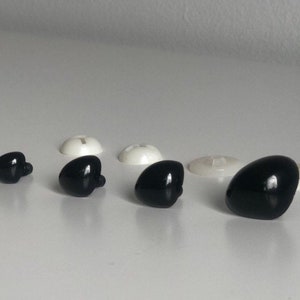 May include: Assortment of black plastic safety eyes for crafts and toy making. The eyes come in various sizes and have a shiny finish.