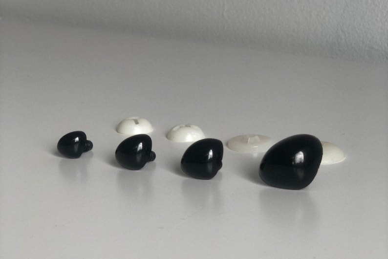 May include: Assortment of black plastic safety eyes for crafts and toy making. The eyes come in various sizes and have a shiny finish.