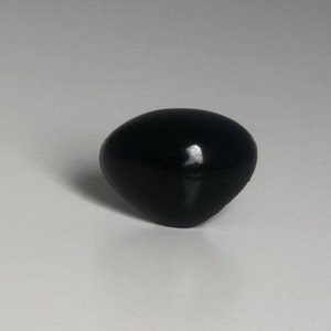 May include: A black plastic knob with a rounded, slightly pointed top.