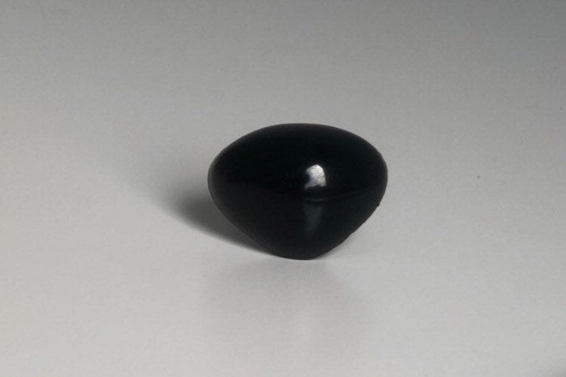 May include: A black plastic knob with a rounded, slightly pointed top.