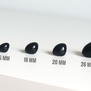 May include: Four black plastic safety eyes in different sizes: 15 mm, 18 mm, 20 mm, and 26 mm.