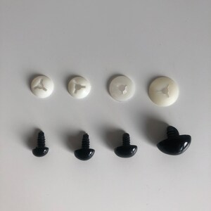 May include: Set of six plastic safety eyes for crafts. Four white plastic washers and two black plastic eyes with screw posts.