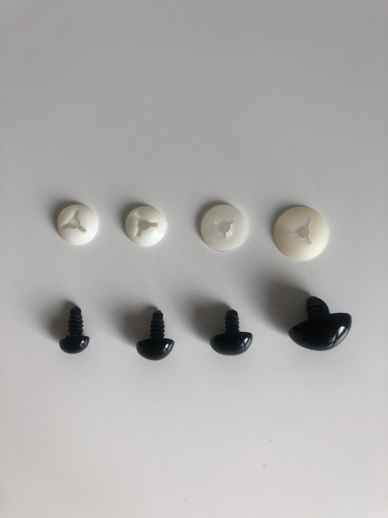 May include: Set of six plastic safety eyes for crafts. Four white plastic washers and two black plastic eyes with screw posts.