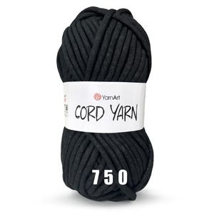 May include: A black ball of YarnArt Cord Yarn, labeled "CORD YARN" with the number "750" printed below the label.