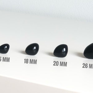 May include: Four black plastic safety eyes in different sizes: 15 mm, 18 mm, 20 mm, and 26 mm.