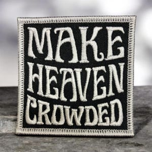 May include: Square black patch with white embroidered text that reads "MAKE HEAVEN CROWDED." The patch has a white border and is likely designed to be sewn onto clothing or accessories. The text is in a bold, stylized font.
