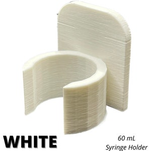 May include: A white 60 mL syringe holder featuring a vertical flat back panel and a circular, open-front clip designed to secure a syringe. The object has a visible layered texture consistent with 3D printing and includes the text WHITE 60 mL Syringe Holder.