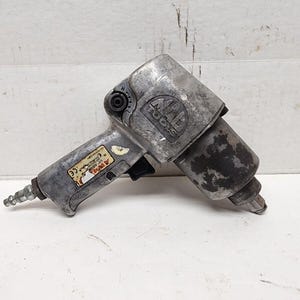 May include: A silver air impact wrench with a black handle and a label that reads "Air Tools".