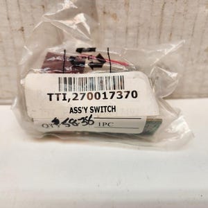 May include: A packaged electrical component labeled "TT1,270017370 ASS'Y SWITCH". The package is clear plastic, and the component has a barcode and a small quantity label. The component appears to have red and white wires.