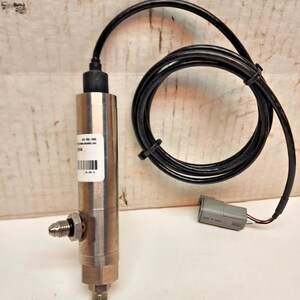 May include: A silver-colored pressure sensor with a black cable and a gray connector. The sensor has a cylindrical body with a label and a threaded fitting. The black cable is coiled and secured with a black tie.