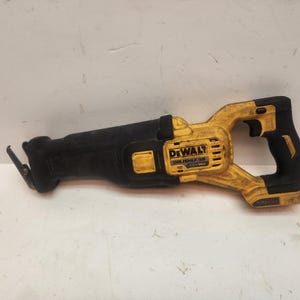May include: A black and yellow DeWalt brushless reciprocating saw. The saw has a black handle and body with yellow accents. The text "DeWalt" and "Brushless" are visible on the saw's body. The saw is designed for cutting various materials.