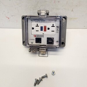 May include: A gray metal electrical outlet box with a clear plastic cover. The box has a standard electrical outlet, an ethernet port, and a text label that reads "GracePort Interface GFCI Inside-Outlet 120VAC, SA FOR COMPUTER USE ONLY".