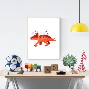 May include: A watercolor painting of a red and orange dinosaur with three horns on its head. The dinosaur is on a white background with splatters of red and orange paint.