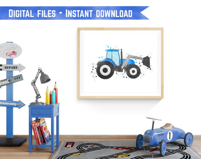 May include: A digital printable featuring a blue tractor with a black bucket, painted in a watercolor style with black splatters on a white background. The tractor is framed in a light wood frame.