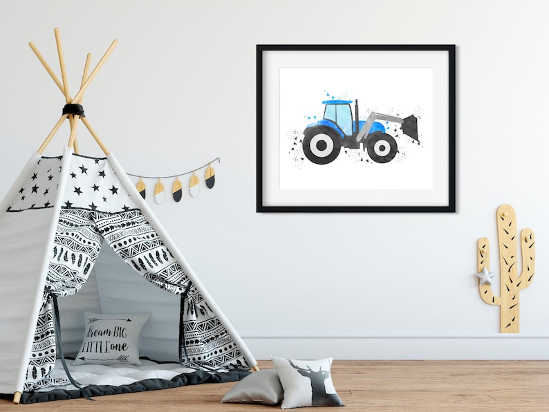 May include: A blue and black watercolor illustration of a tractor with a bucket, framed in a black frame. The image is hanging on a white wall in a nursery.
