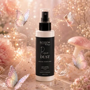May include: A white cylindrical spray bottle with a black label featuring the text Blossom Brew Pixie Dust Room Perfume, Fizzy Sherbet Marshmallow Plum, Made in Melbourne, 100ml | 3.3 oz. The bottle has a black pump nozzle and a clear cap.