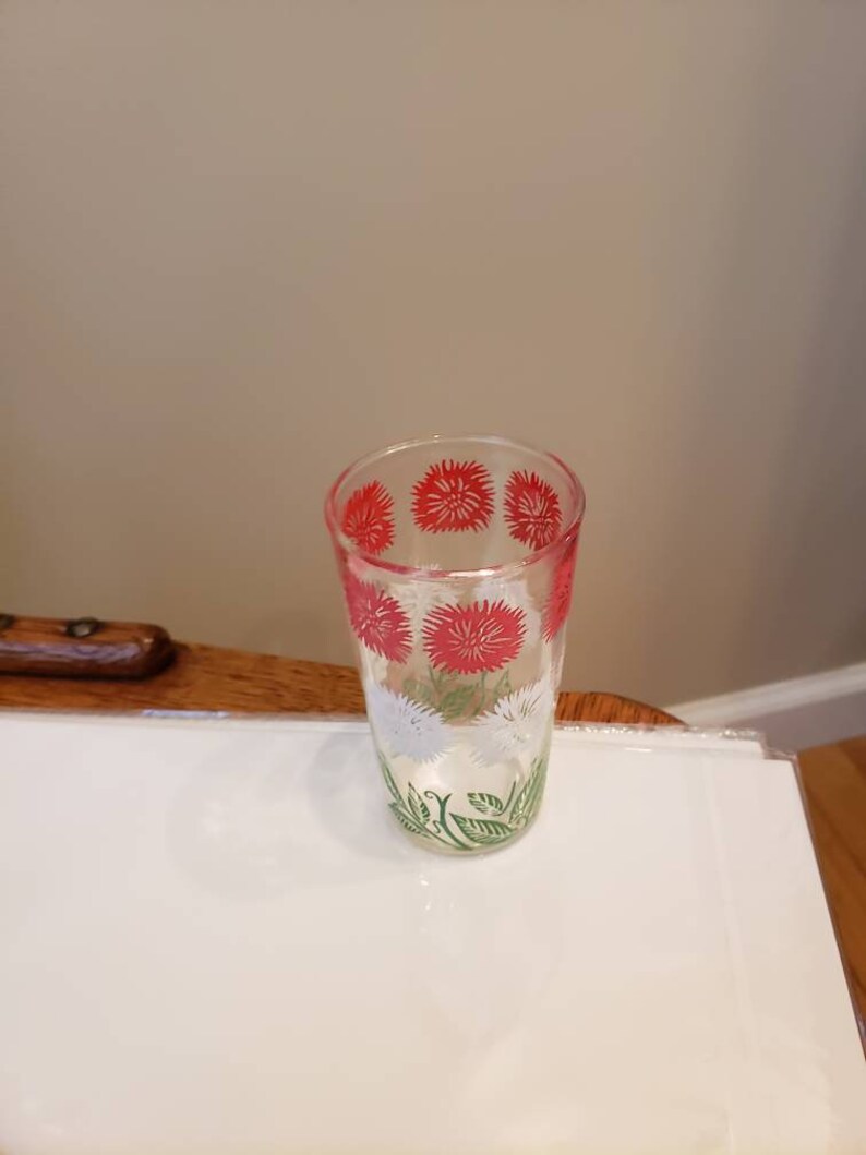 White and Green Daisy pattern Swanky Swigs Juice Cups with a Red 3 12 tall.