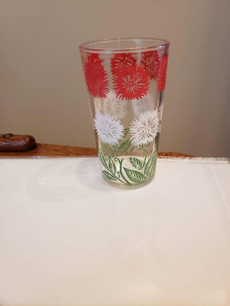White and Green Daisy pattern Swanky Swigs Juice Cups with a Red 3 12 tall.