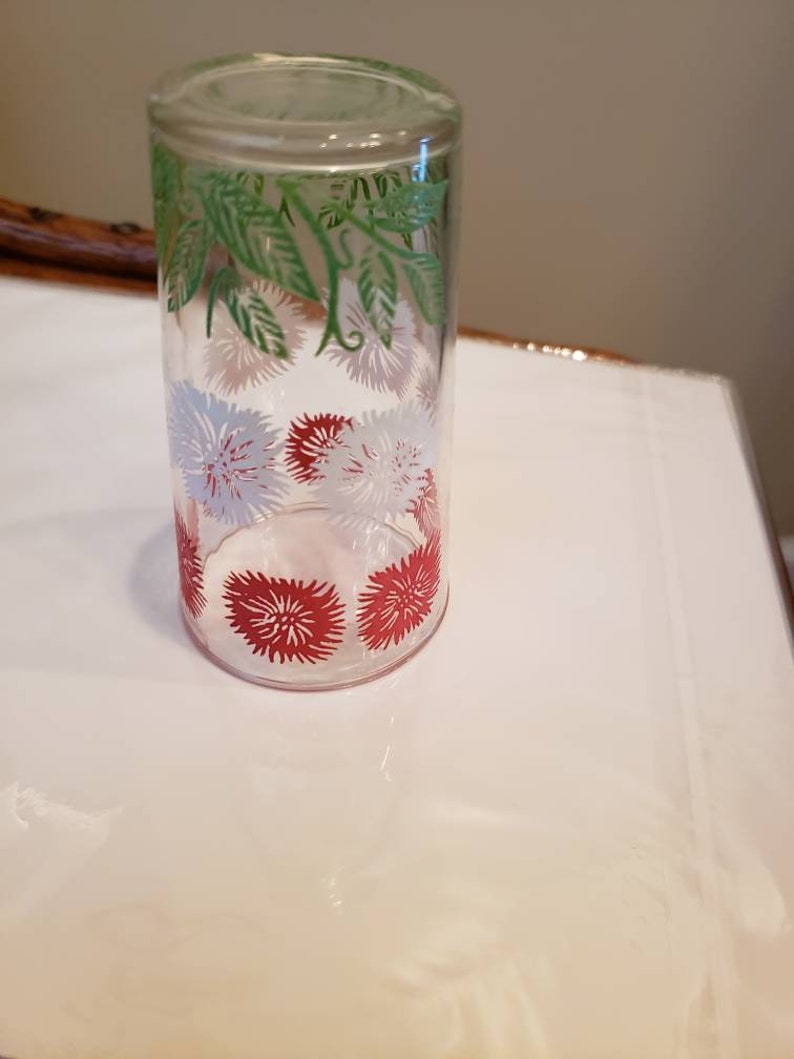 White and Green Daisy pattern Swanky Swigs Juice Cups with a Red 3 12 tall.