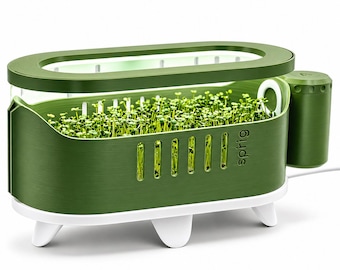 May include: An olive green indoor hydroponic garden planter with a white base and three legs. The unit features a top light fixture, a side water reservoir, and vertical ventilation slots. The word sprig is printed on the side, and the planter contains small green sprouts.