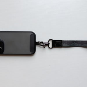 midnight mountain black keychain. Printed with mountains and stars attached to phone
