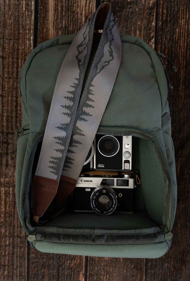 camera strap with printed mountains and trees