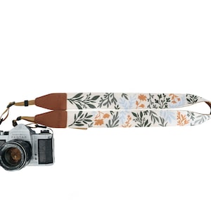 Wildflower Design camera strap with brown vegan leather ends and backing.