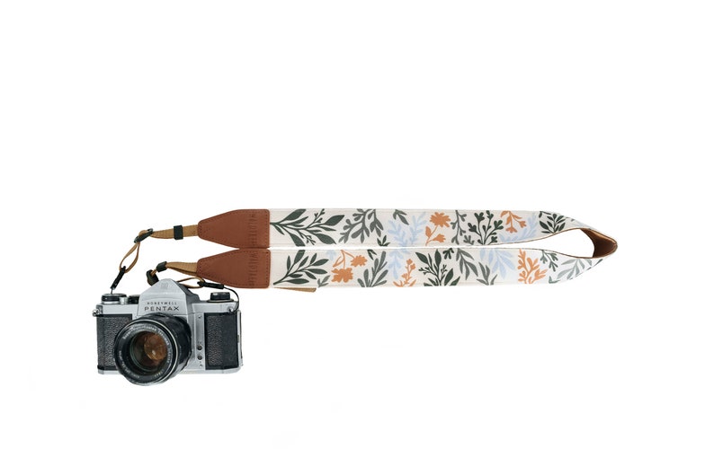 Wildflower Design camera strap with brown vegan leather ends and backing.