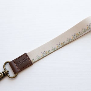 flower field dainty floral wristlet keychain with brown leather ends