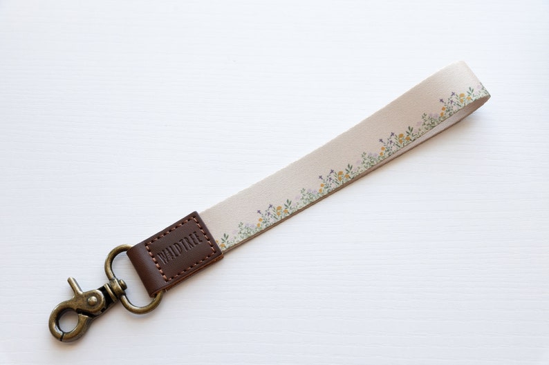 flower field dainty floral wristlet keychain with brown leather ends