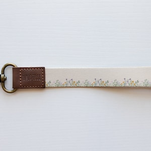 flower field dainty floral wristlet keychain with brown leather ends