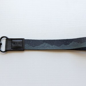 midnight mountain black keychain. Printed with mountains and stars.