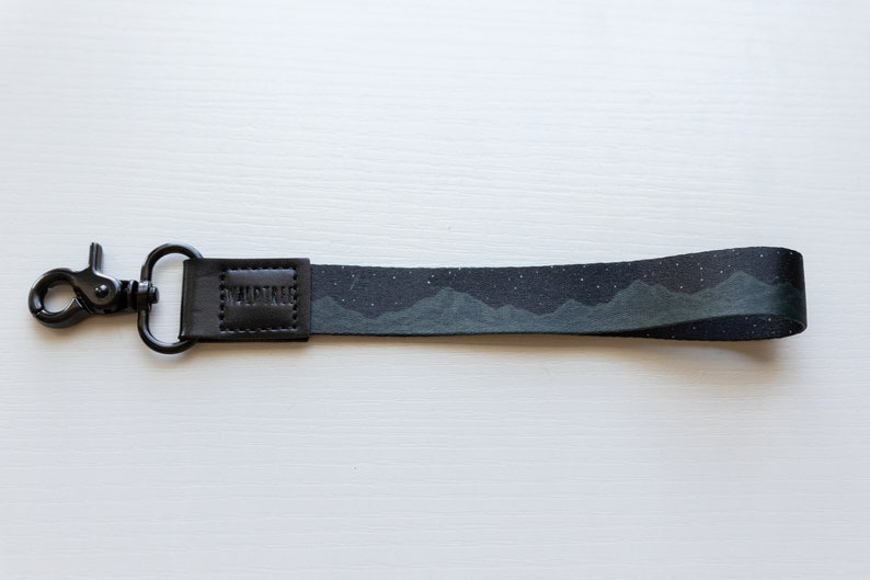 midnight mountain black keychain. Printed with mountains and stars.