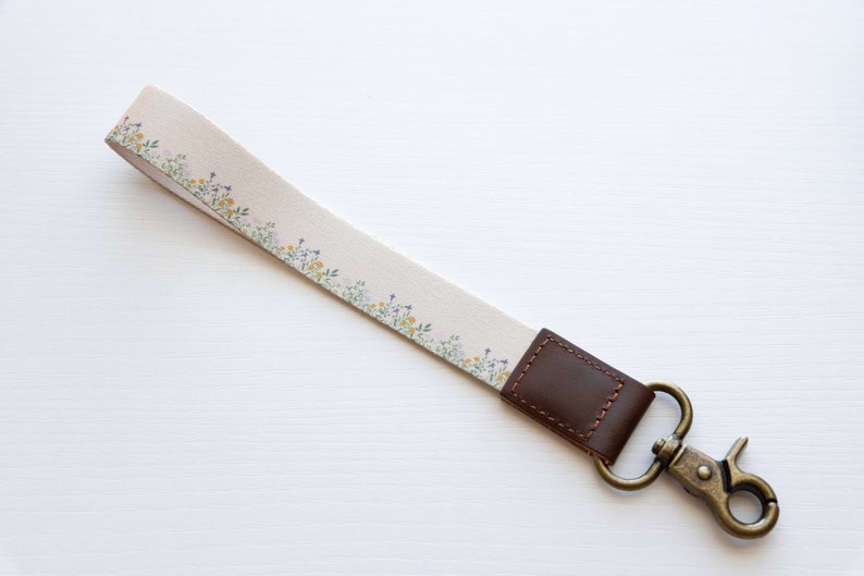 flower field dainty floral wristlet keychain with brown leather ends