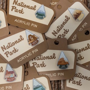 a group of national park acrylic pin showing other pins for sale in my shop