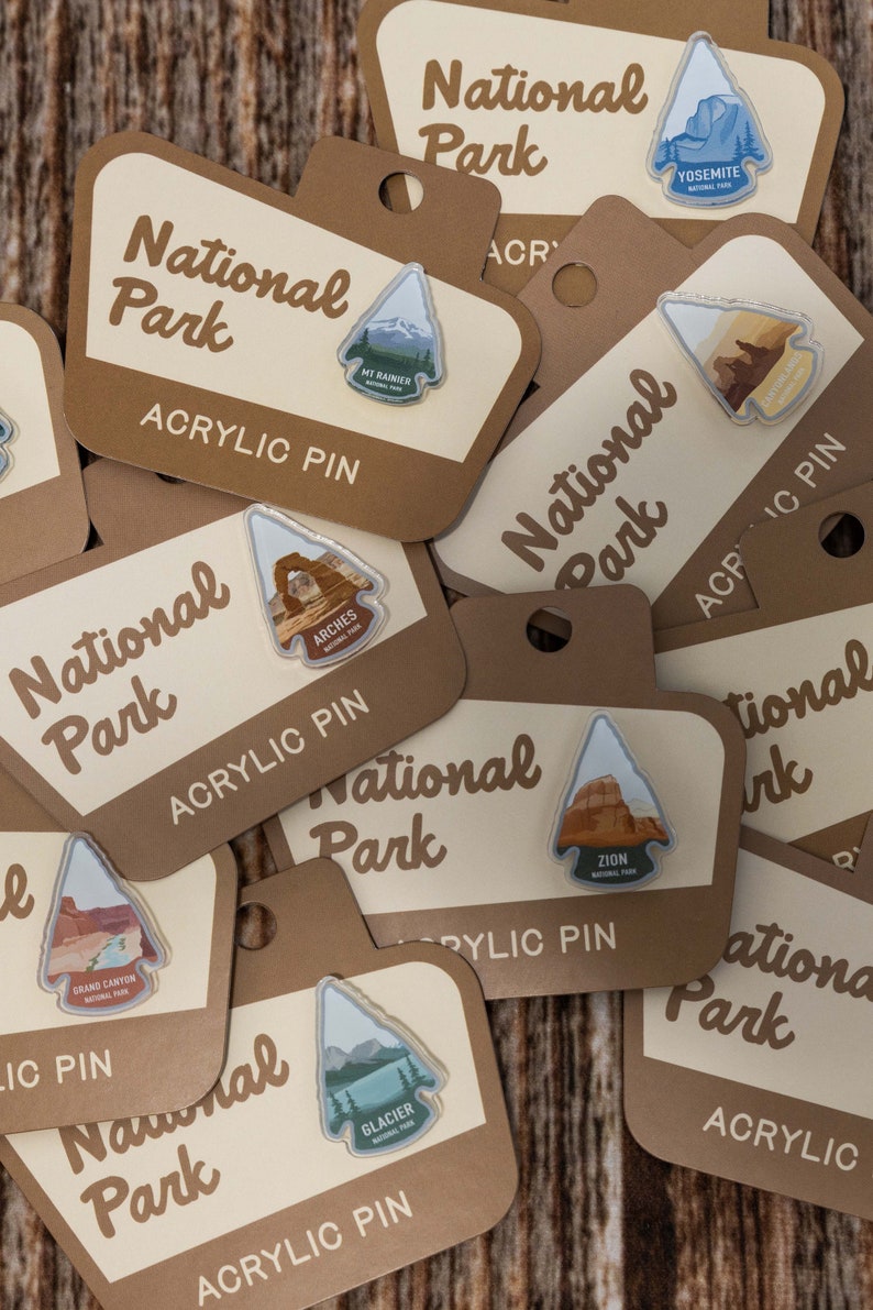 a group of national park acrylic pin showing other pins for sale in my shop