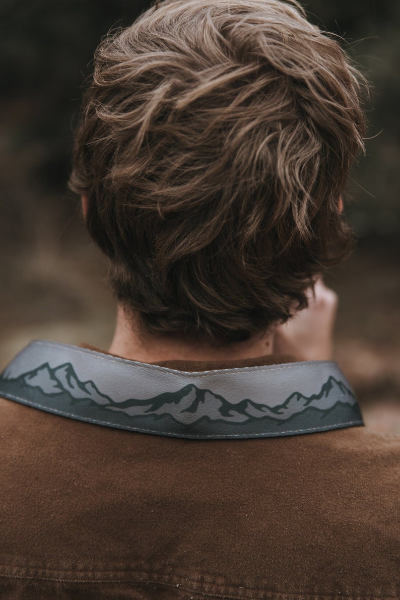 camera strap with printed mountains and trees